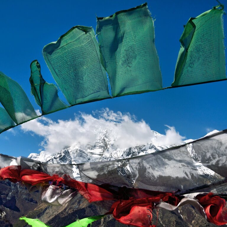Buddhist Prayer flags against Annapurna range covered with snow, way to Ice lake, 4600 m above sea, Annapurna Circuit Trek, Himalayas, Nepal
